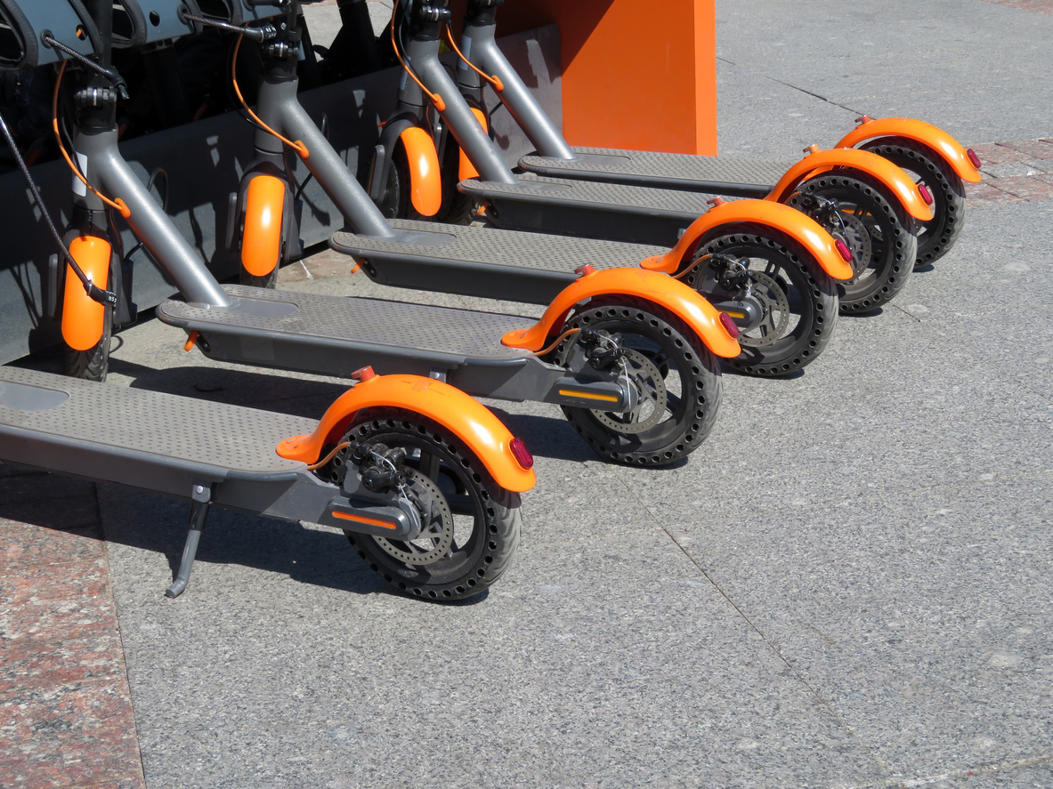 Electric scooters in row on the parking lot