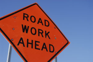 Construction road sign against a blue sky