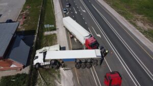 File a Claim for a Truck Accident Top view of a car accident involving a truck and a bus. Filming from a drone