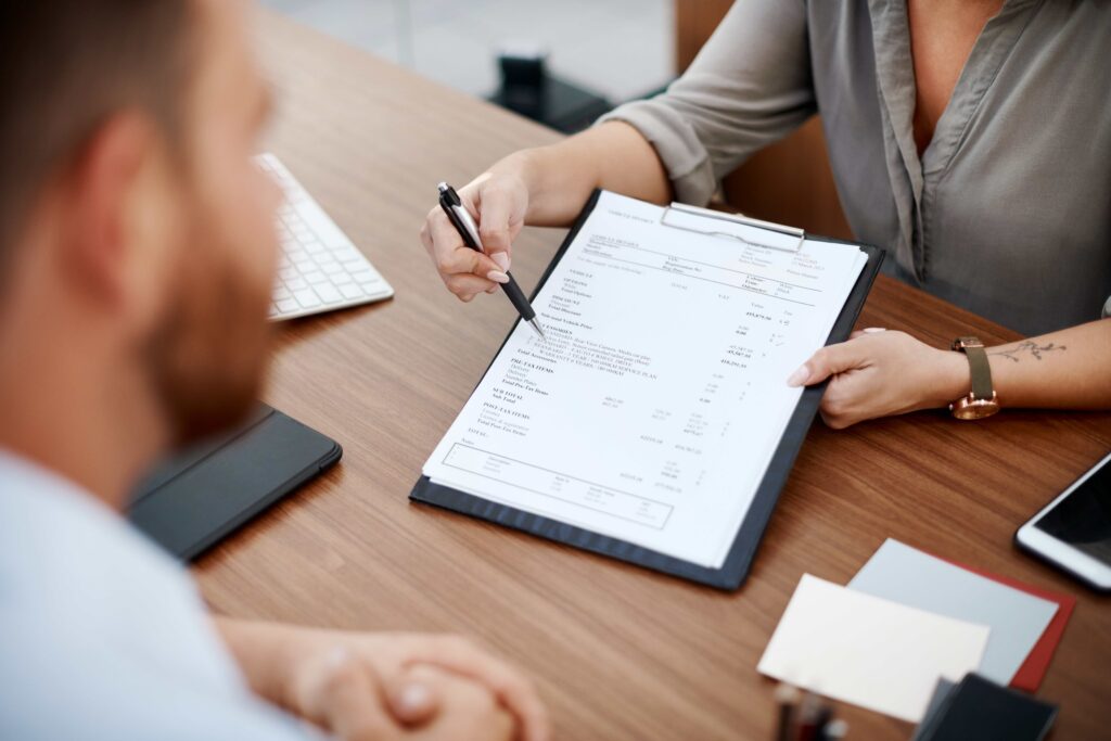 Worker reading a benefits letter at a kitchen table