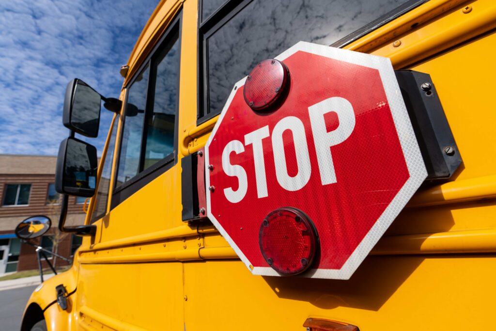 School bus with its stop arm extended on a residential street