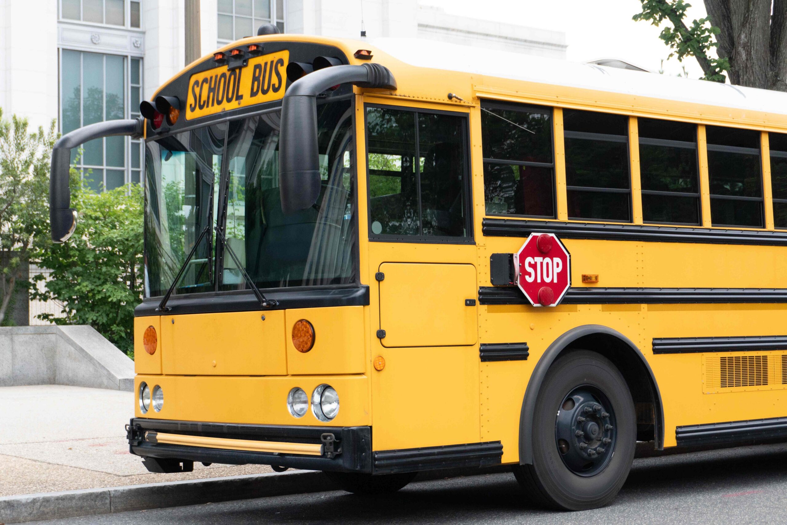 Yellow school bus parked along a curb